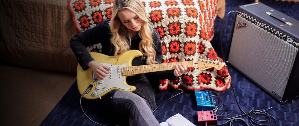 Woman Playing Fender Player Stratocaster.