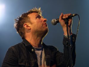 Damon Albarn singing into a mic